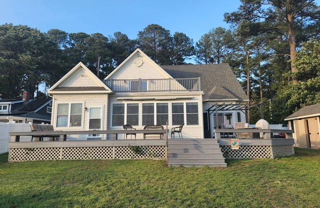 Waterfront home with dock, gazebo, and fenced yard