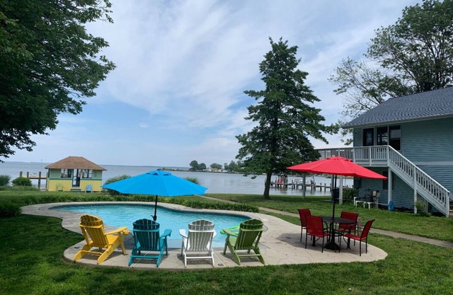 Waterfront property on 3/4 acres with private beach, pool, hot tub, and pier.