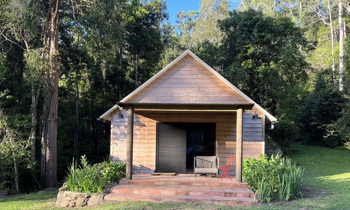 Cedar Brush Creek Cabin | Cedar cabin in serene cool setting in rainforest bush, traditional luxe