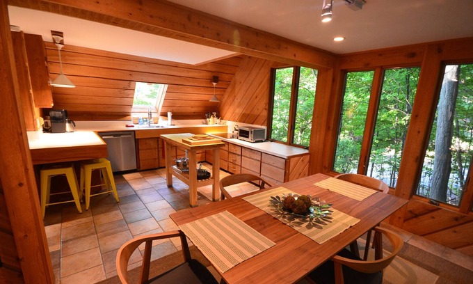 Suttons Bay Cabin | Cozy cottage high in the trees. Walk to the beach. Small dog considered.