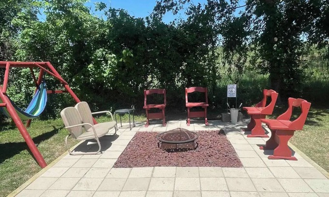 Dennis Cottage | Enjoy the river with a pool, firepit and a balcony with a gorgeous water view.