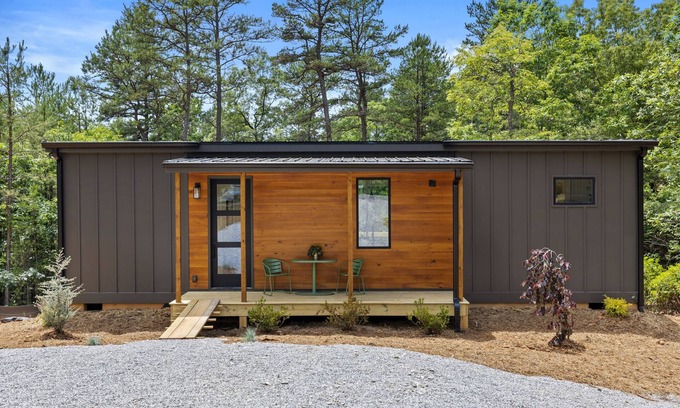 Young Harris Apartment | Escape to a 2BR/1BA tiny home in the North Georgia mountains. Create meals in the chef’s kitchen, cozy up by the wood-burning stove, refresh in the spa-style shower, and enjoy crisp mountain air and brilliant fall colors from your private deck.