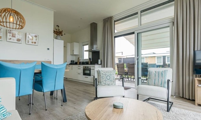 Burgh-Haamstede House | Garden-oriented, bright living room with an adjoining (electrically operated) patio cover Lush garde