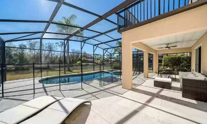 Lake Wilson Preserve House | Gorgeous water view from South facing pool deck. Balcony off upstairs master bed