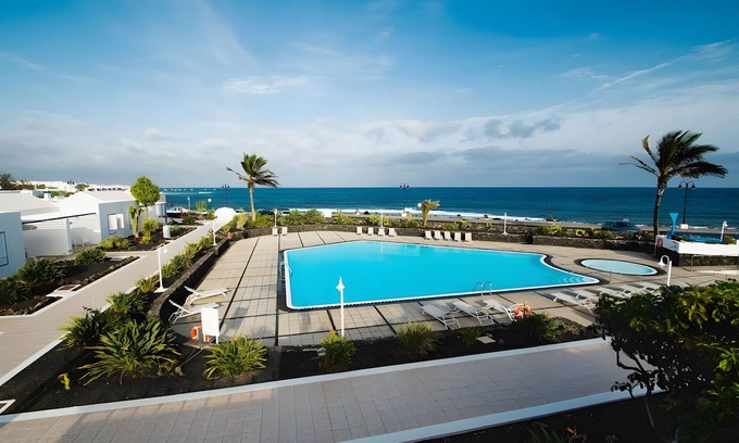 Arrieta House | Holiday Home 'Caleta Campos Bungalows' with Sea View, Shared Pool and Wi-Fi