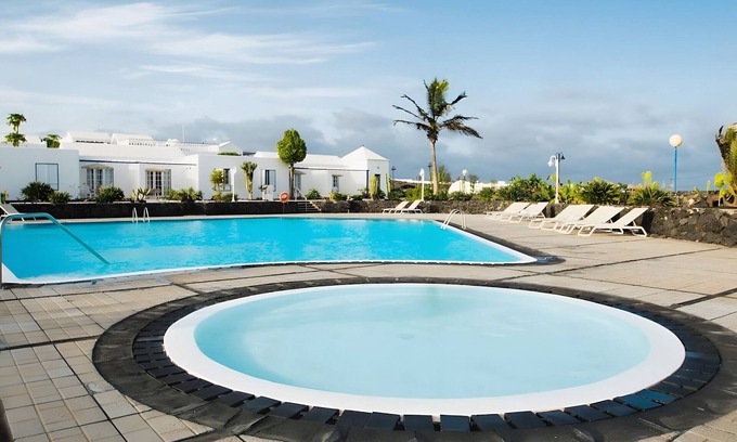 Arrieta House | Holiday Home 'Caleta Campos Bungalows' with Sea View, Shared Pool and Wi-Fi