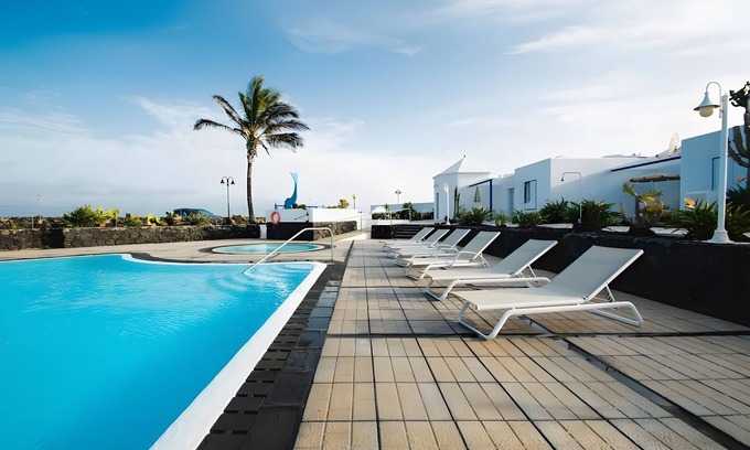 Arrieta House | Holiday Home 'Caleta Campos Bungalows' with Sea View, Shared Pool and Wi-Fi