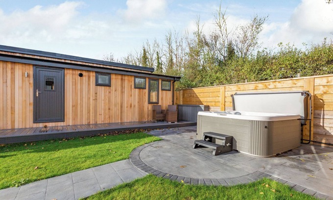 Middlezoy Ski Chalet | Luxurious lodge with vaulted ceilings and a welcoming feature fireplace.