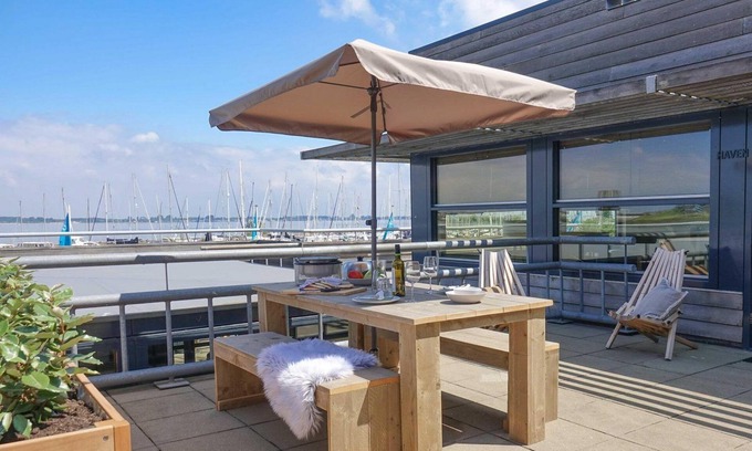 Stellendam House | Luxury apartment with private terrace, spacious living room, and stunning views of the marina.