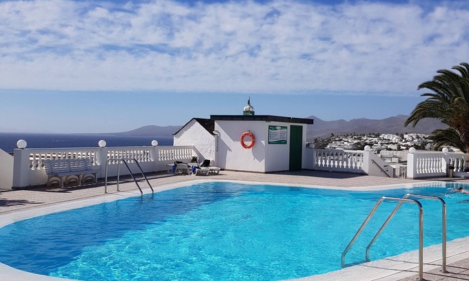 Puerto del Carmen Apartment | Modern apartment ,stunning sea and mountain views in the old town. WiFi and pool