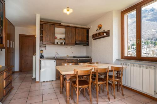 Barzio Apartment | Mountain lodging with fireplace and mountain view