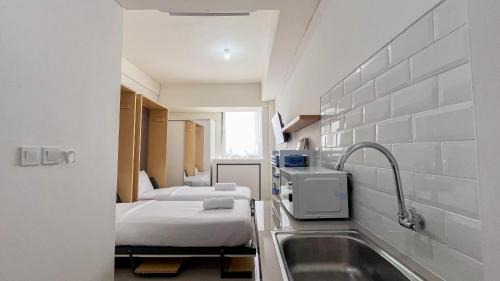 Makassar Apartment | Restful Studio (No Kitchen) Apartment at Bandaraya - Tallasa City Makassar By Travelio