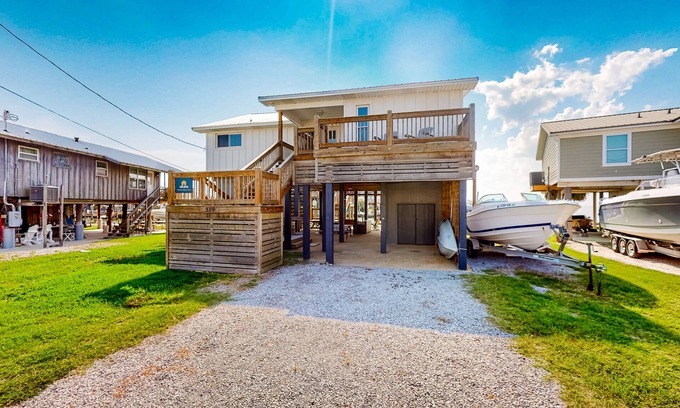 Royal Lagoons House | Serene sound-front home with a covered patio, dock, and swing bed