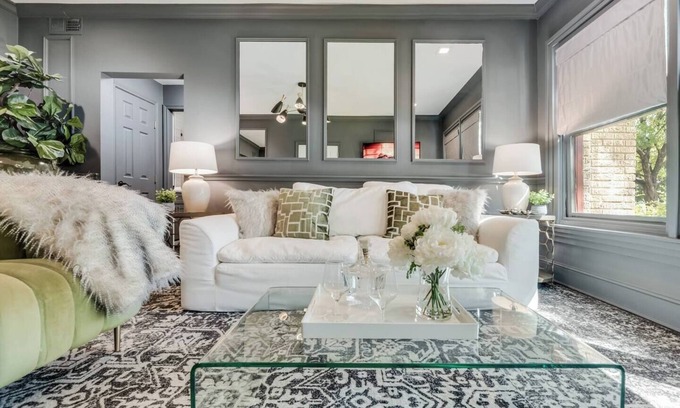 Old East Dallas Condo | Step into refined comfort in this charming Dallas jewel box, where historic architecture meets luxury finishes. Featuring a hand-scraped hardwood foyer, Carrera marble bath, high-end kitchen, and award-winning courtyard.