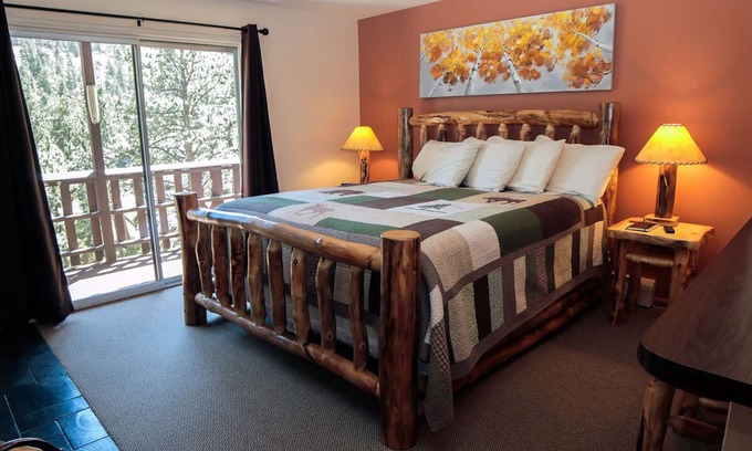 Estes Park Condo | Suite features King bed, full kitchen, and deck with a river view.