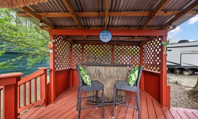 Milton RV Rental | THIS IS AN AWESOME 36' RENTAL CAMPER WITH AMAZING LONG DECK, PLUS A SECOND STEP-DOWN DECK TO YOUR OWN PRIVATE HIDEAWAY TIKI BAR! A BEAUTIFUL HUGE LIVE OAK COVERS THE ENTIRE LOT SO IT'S ALWAYS SHADED, AND THIS EVEN COMES WITH A TABLE & CHAIRS FOR OUT