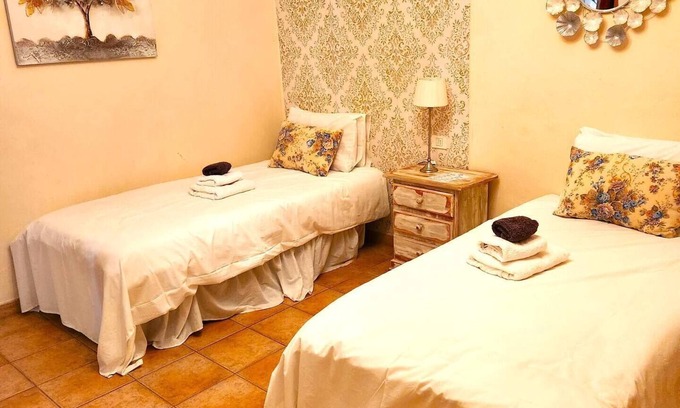 Vilaflor Apartment | This room has two single beds with an en-suite bathroom. The room looks onto the road and has mountain views to the rear of the building.