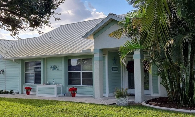 Cape Coral Villa | Villa Coral Cove heated pool, large lanai, lounge and fire pit in For Mile Cove