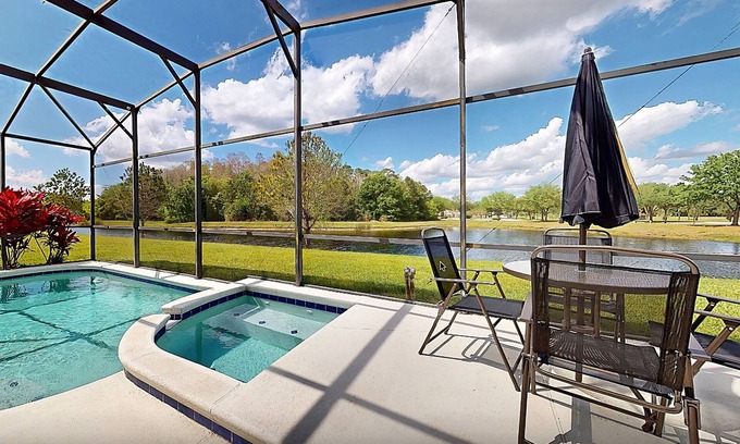 Trafalgar Village House | Water view retreat with lanai, heated pool, pool spa, game room, & AC
