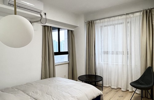Huaihai Road Commercial Area Apartment | peaceful urban retreat in a stylish minimal apartment with views across the city